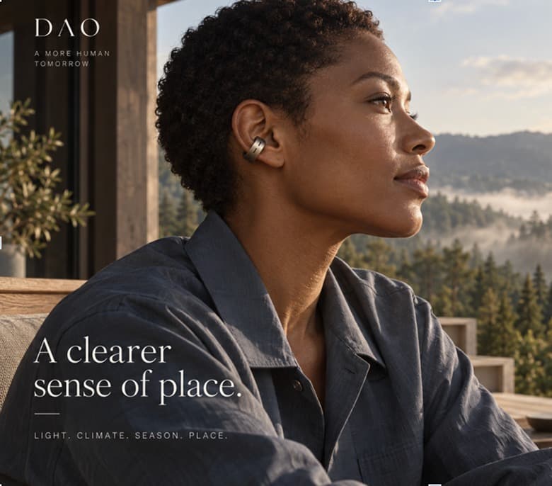 A woman wearing the Dao ear cuff, looking out over a forested valley, captioned “A clearer sense of place.”